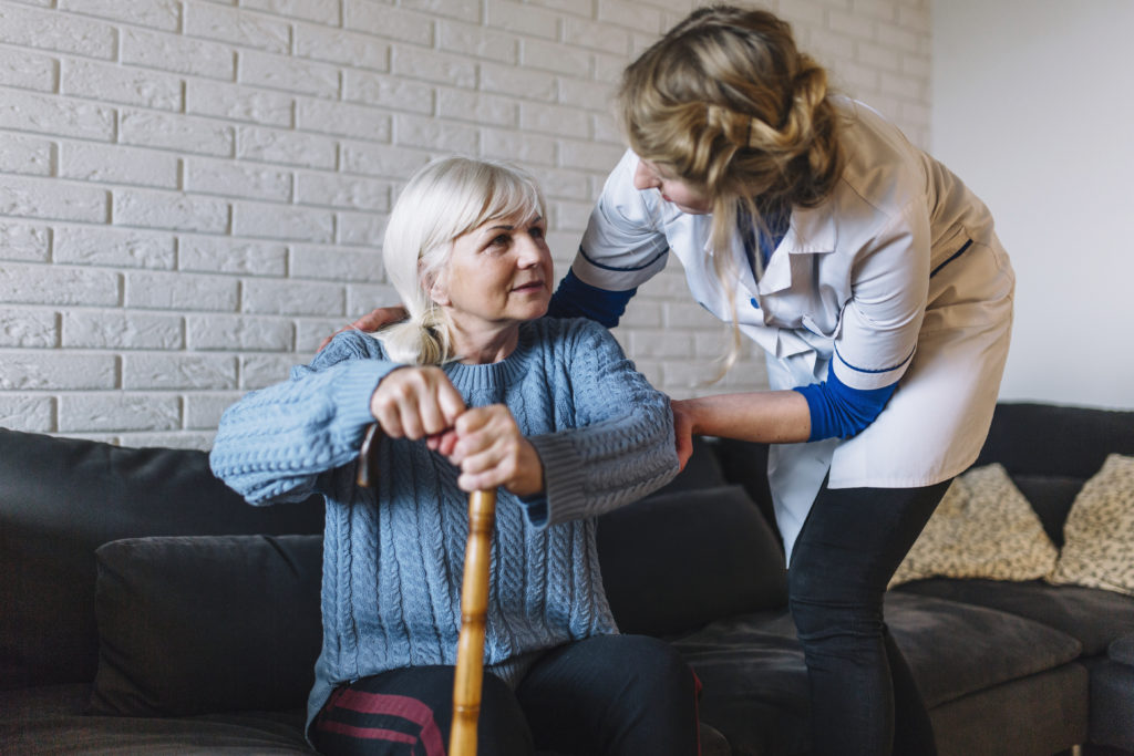 Care worker helping a service user at home